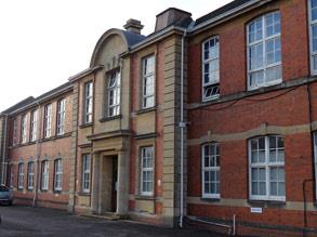 School building suffering from water ingress and dirt on the brickwork